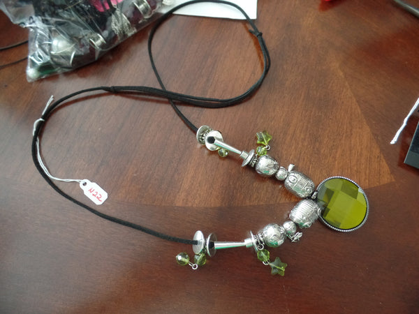 FUNKY NECKLACE W/FOREST GREEN FOCAL...SUEDE EXPANDABLE CORD WITH SILVER AND GREEN BEADS. FOCAL IS EYE CATCHING!!