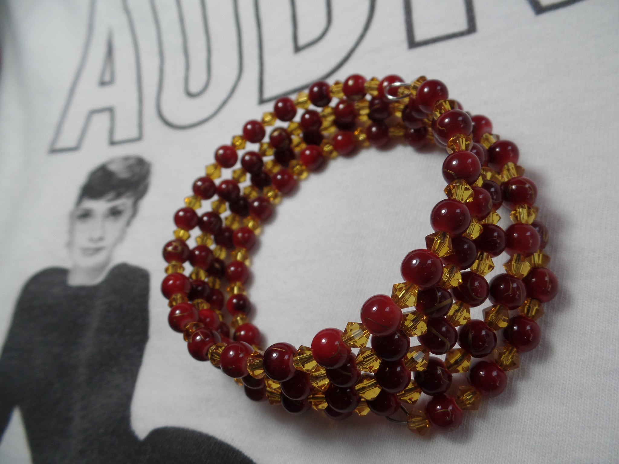 Dark red glass beads w/gold bicone beads on memory wire.