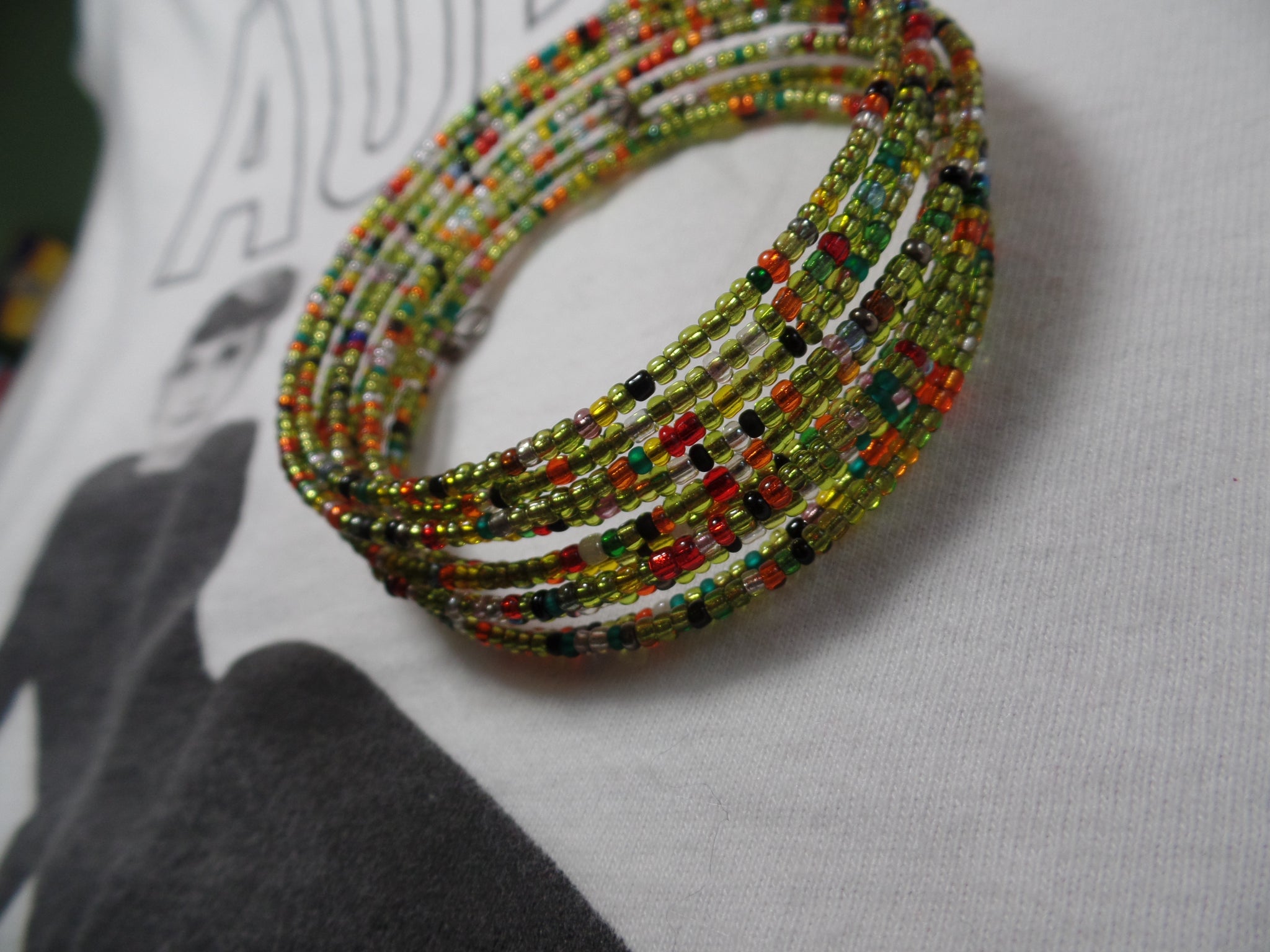 Multicolored glass seed beads on memory wire